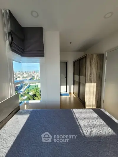 Modern bedroom with city view and ample natural light