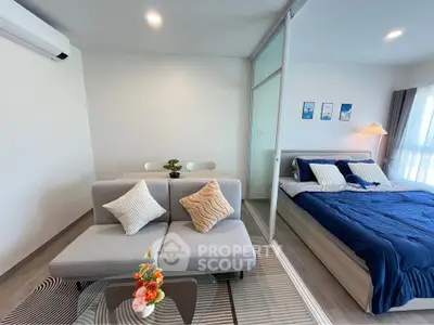 Modern studio apartment with cozy living area and stylish bedroom, featuring contemporary decor and ample natural light.