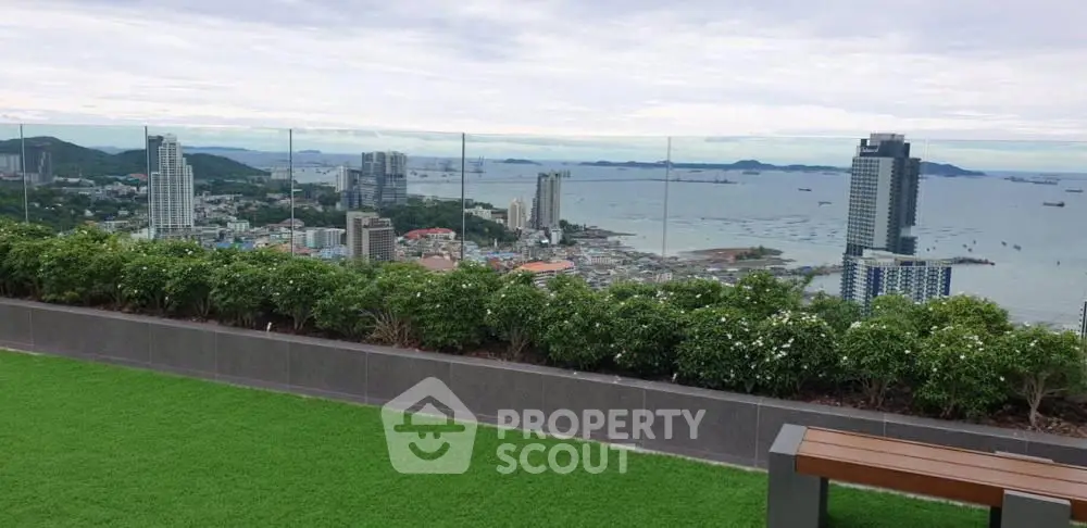 Stunning rooftop view with lush greenery overlooking city skyline and ocean