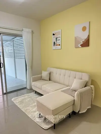 Cozy living room with modern beige sofa and stylish decor, perfect for relaxation and comfort.