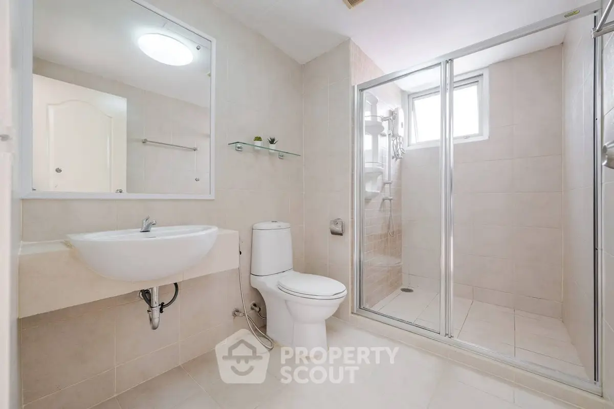 Spacious modern bathroom with shower and elegant fixtures