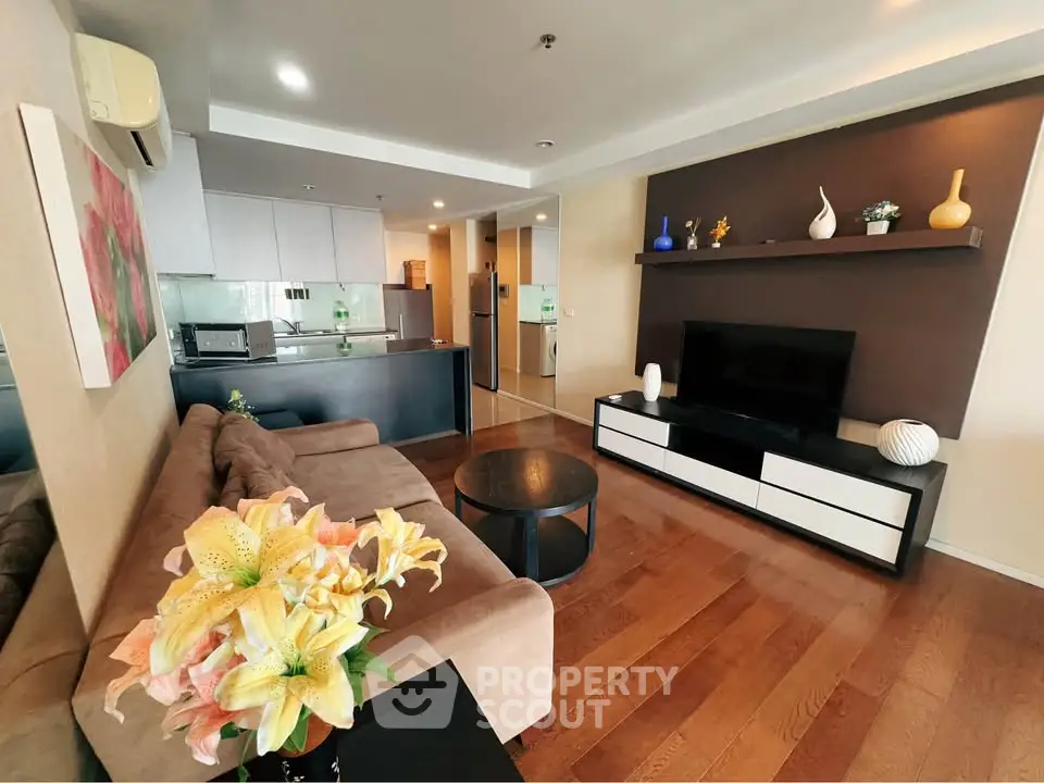 Spacious modern living room with stylish decor and open kitchen layout, perfect for entertaining.