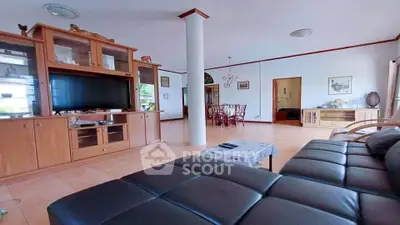 Spacious living room with elegant furniture and open layout, perfect for family gatherings.