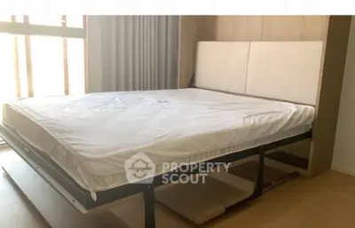 Modern bedroom with stylish foldable bed and natural light