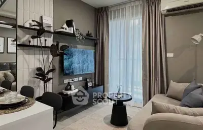 Modern living room with sleek decor and natural light, featuring a wall-mounted TV and cozy seating area.