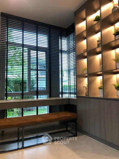 Modern interior with stylish shelving and large windows in a contemporary living space.