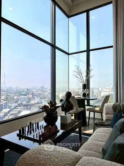 Luxurious high-rise living room with panoramic city views and elegant decor.