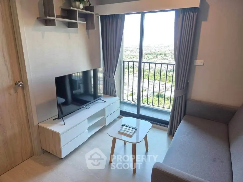 Modern living room with balcony view, sleek furniture, and natural light.