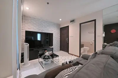 Modern living room with stylish decor and open view to bathroom