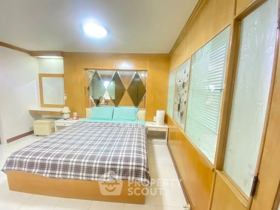 Cozy bedroom with modern decor and ample natural light, featuring a comfortable bed and stylish furnishings.