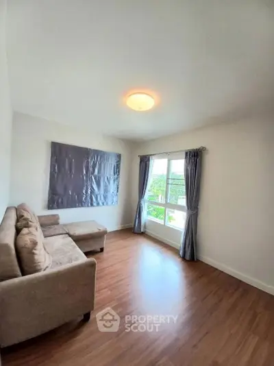 Spacious living room with modern sofa and large window view
