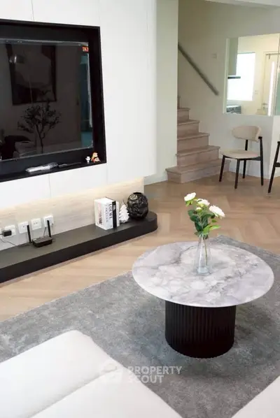 Modern living room with stylish marble coffee table and sleek entertainment unit