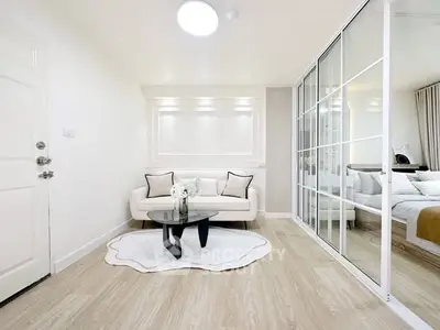 Modern living room with elegant white decor and glass sliding doors