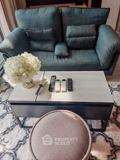 Cozy living room with plush sofa, stylish coffee table, and elegant decor for a welcoming ambiance.