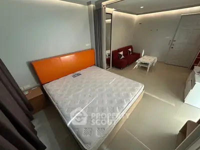 Modern bedroom with stylish decor and cozy seating area, perfect for relaxation and comfort.