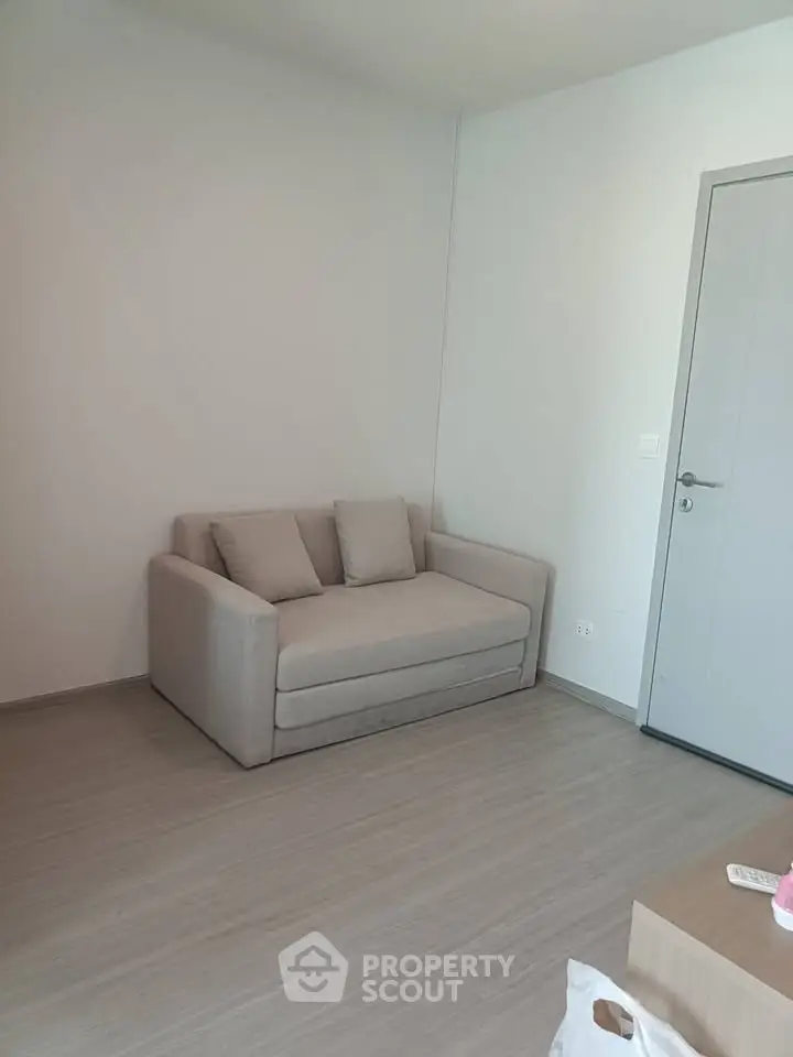 Minimalist living room with modern sofa and sleek wooden flooring