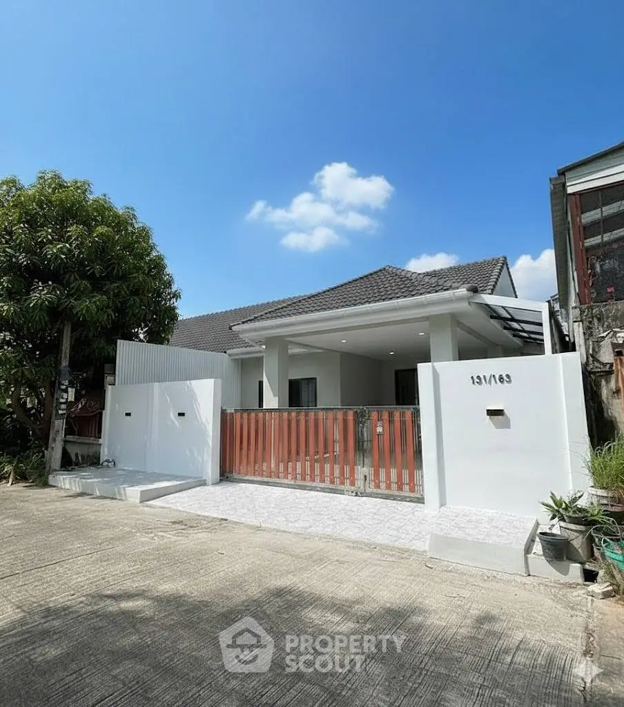 Charming single-story house with modern design and gated entrance, perfect for family living.