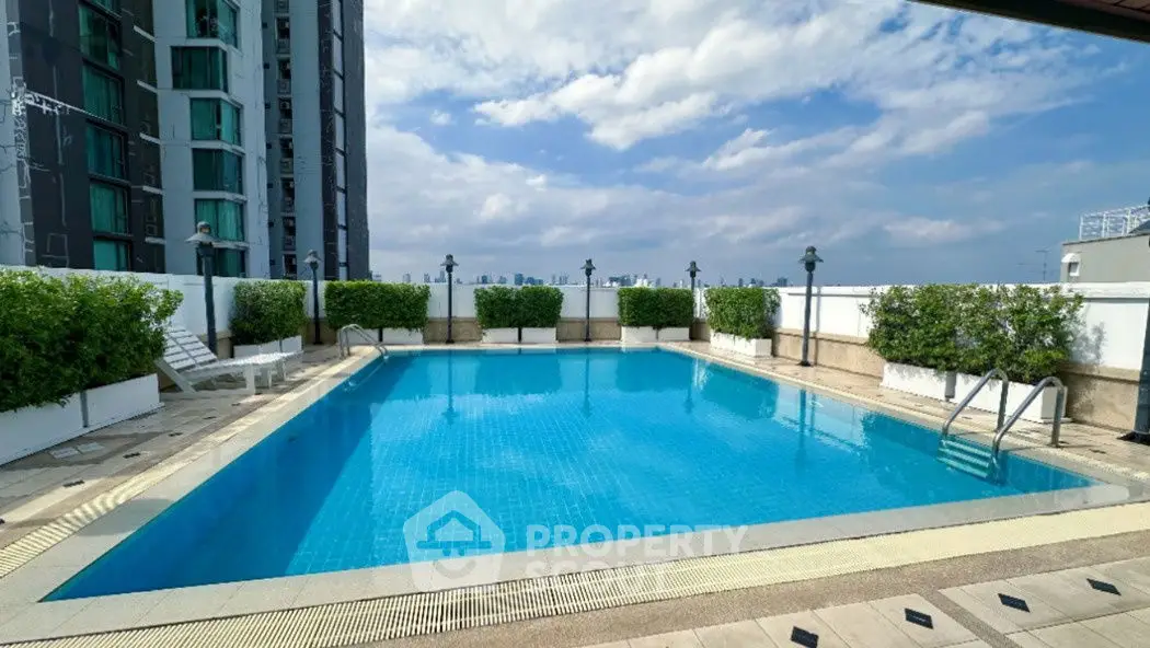 Luxurious rooftop pool with city skyline views, perfect for relaxation and leisure.