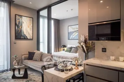 Modern studio apartment with stylish decor and open layout, featuring a cozy living area and elegant bedroom.