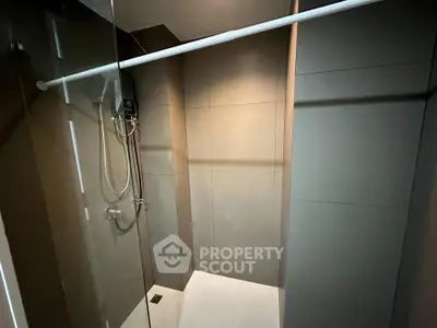 Modern minimalist bathroom with sleek shower design and neutral tones.