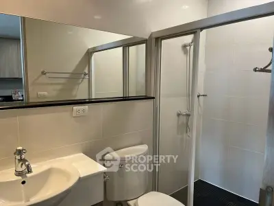Modern bathroom with sleek fixtures and glass shower enclosure