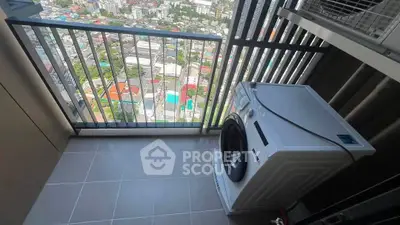 High-rise balcony with washing machine and stunning city view, perfect for urban living.