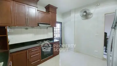 Spacious kitchen with modern gas stove and elegant wooden cabinets