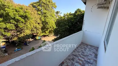 Charming balcony with scenic garden view, perfect for relaxation and outdoor enjoyment.