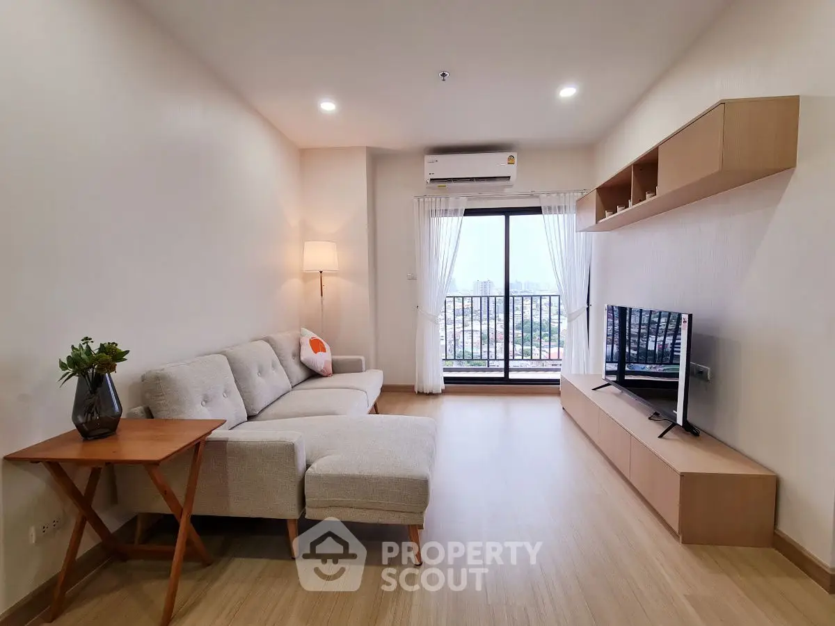Modern living room with cozy sofa and city view balcony