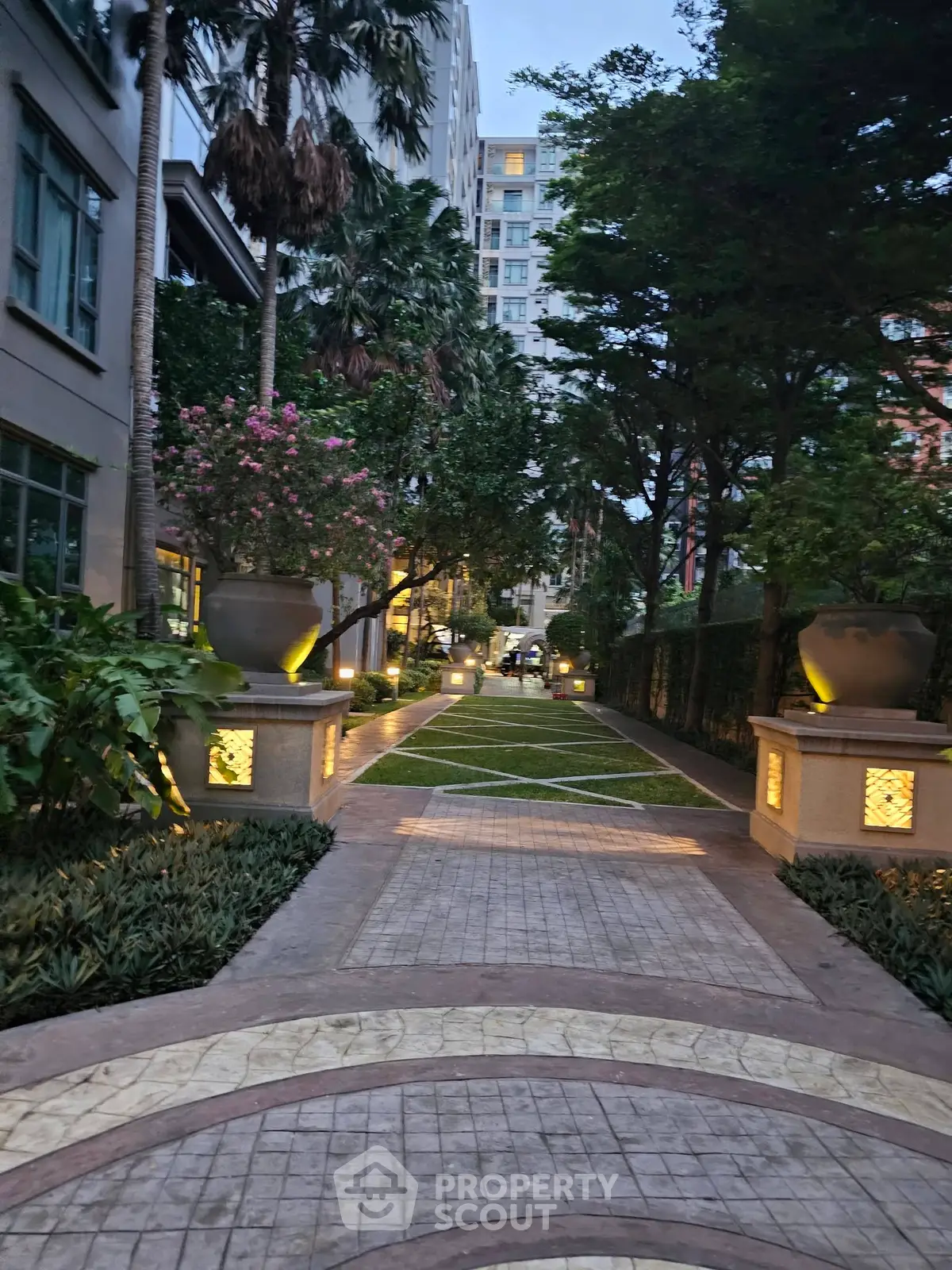 Luxurious garden pathway with elegant lighting in upscale residential complex