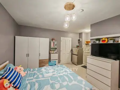 Cozy bedroom with modern decor and ample storage in a stylish apartment.