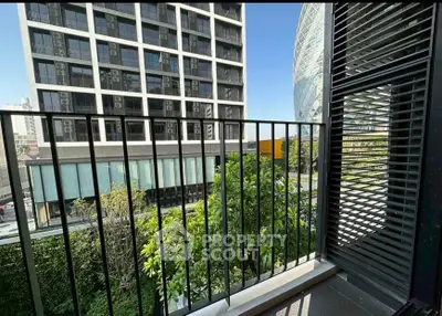 Modern balcony with city view, featuring sleek railing and lush greenery, perfect for urban living.