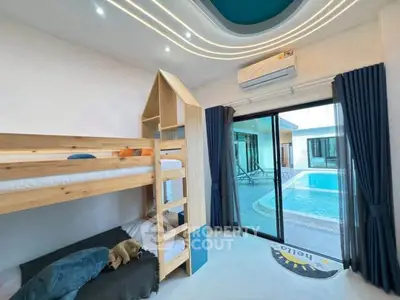 Modern bedroom with bunk bed and pool view, featuring sleek design and ample natural light.