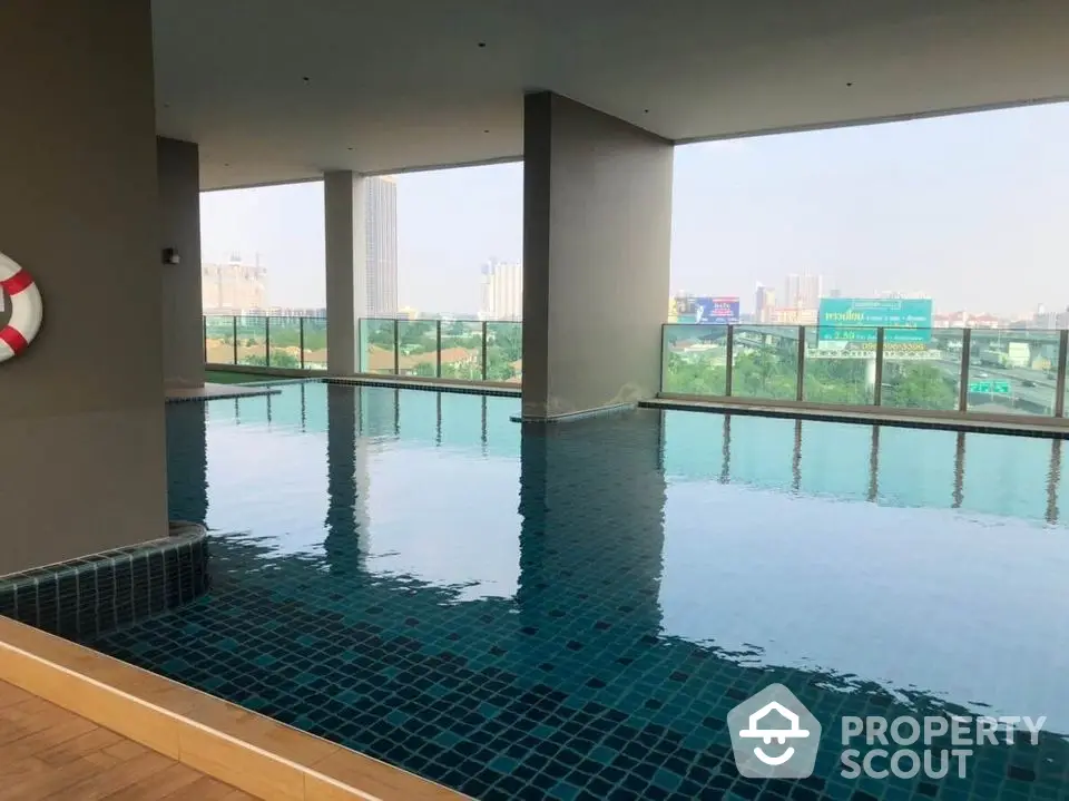 Luxurious rooftop pool with stunning city views in modern high-rise building.