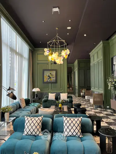 Luxurious living room with modern decor and plush seating in elegant green and blue tones.