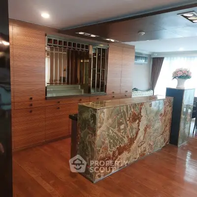 Luxurious living room with elegant wooden cabinetry and stunning marble bar counter