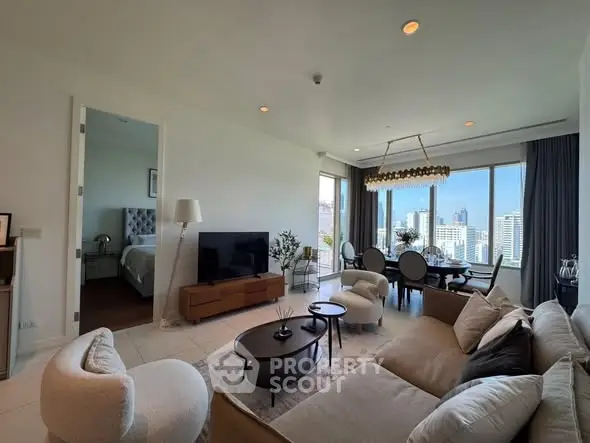 Luxurious living room with city view, elegant furniture, and open dining area in modern apartment.