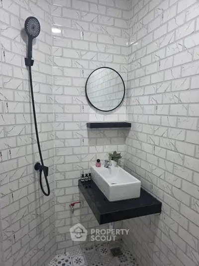 Modern bathroom with sleek black fixtures and stylish white brick tiles.