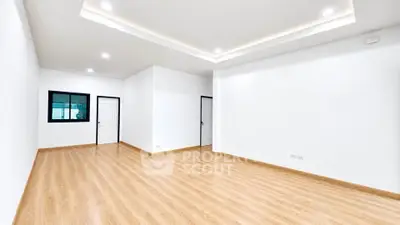 Spacious modern living room with wooden flooring and recessed lighting