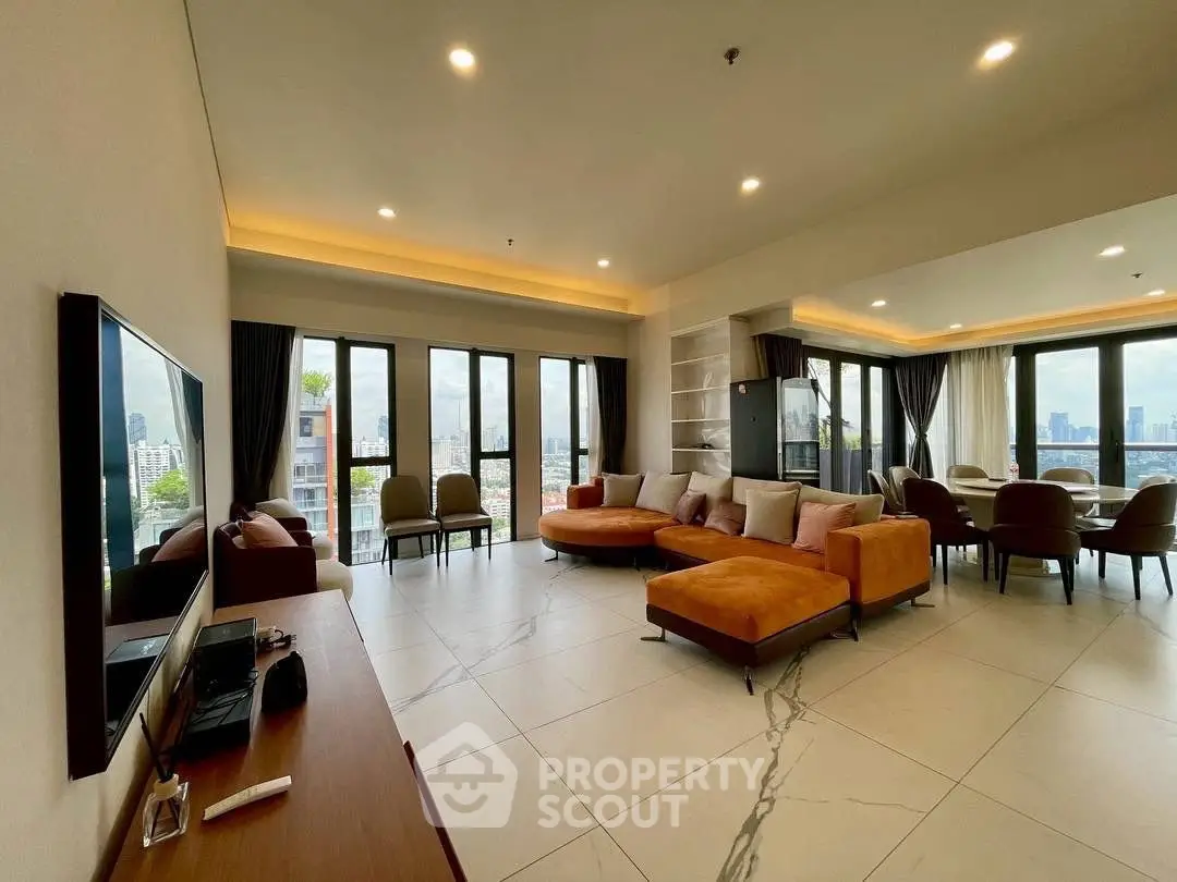 Spacious modern living room with panoramic city views and elegant furnishings.