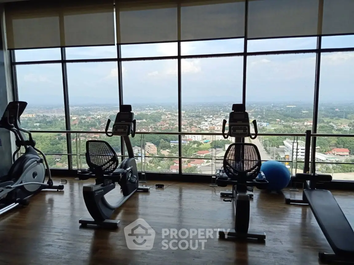 Stunning gym with panoramic city views and modern exercise equipment.