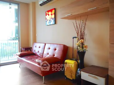 Modern living room with stylish red sofa and large window view