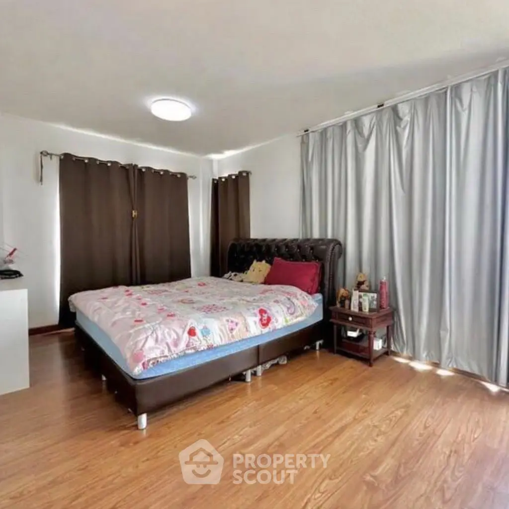 Spacious bedroom with elegant decor and natural light