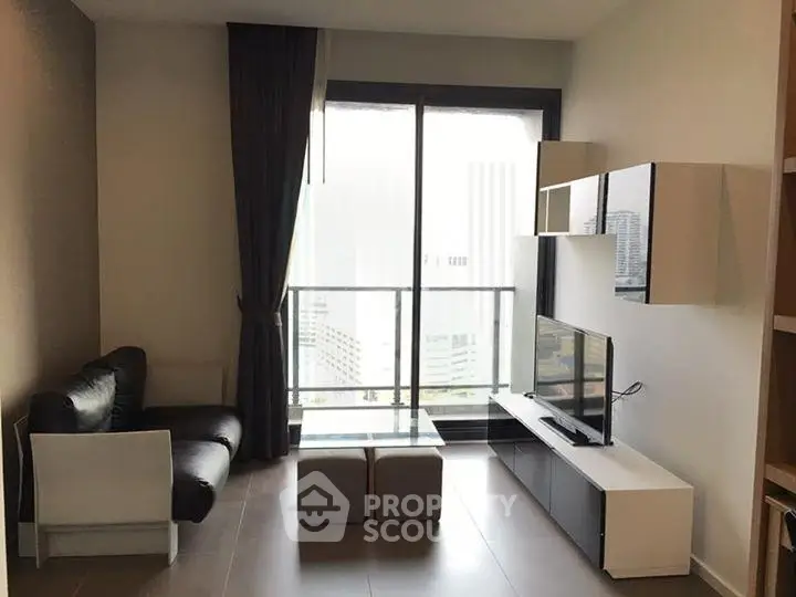 Modern living room with sleek furniture and large window offering city view