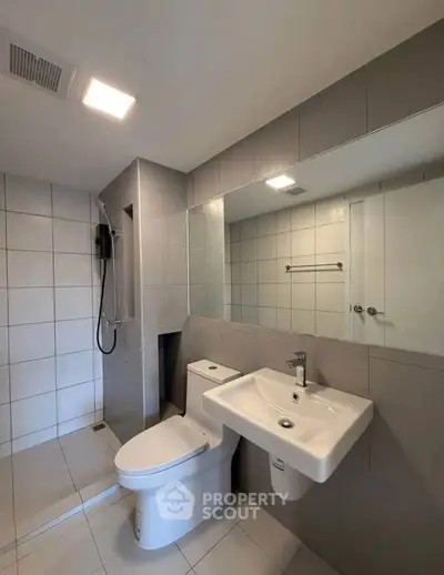 Modern bathroom with sleek fixtures and spacious shower area