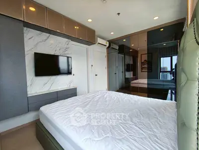 Modern bedroom with stylish decor and large windows offering city views.