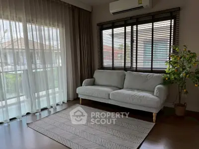 Spacious living room with large windows and modern decor