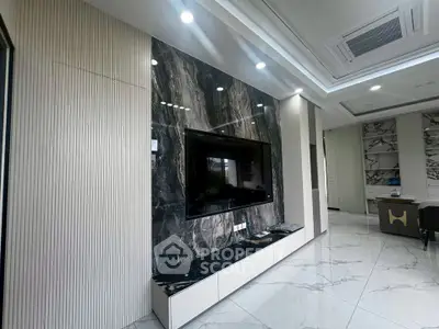 Luxurious modern living room with marble accent wall and sleek TV setup