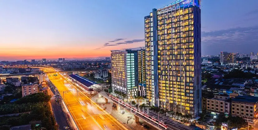 Stunning cityscape view of modern high-rise buildings at sunset, showcasing urban living.