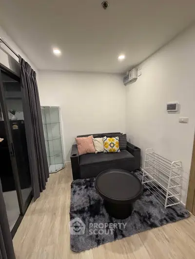 Cozy living room with modern decor and plush seating in a stylish apartment.